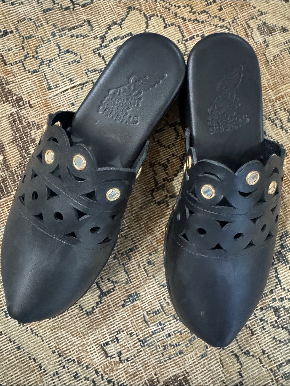 Ancient Greek Sandals Black Leather Cutout Slip-On Mules with Gold Eyelets